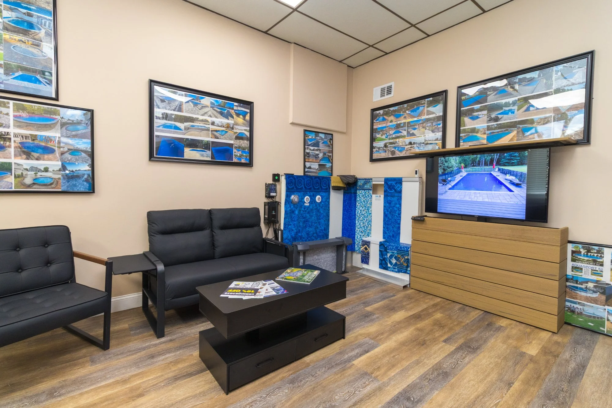 Showroom consultation area with TV showcasing pool projects