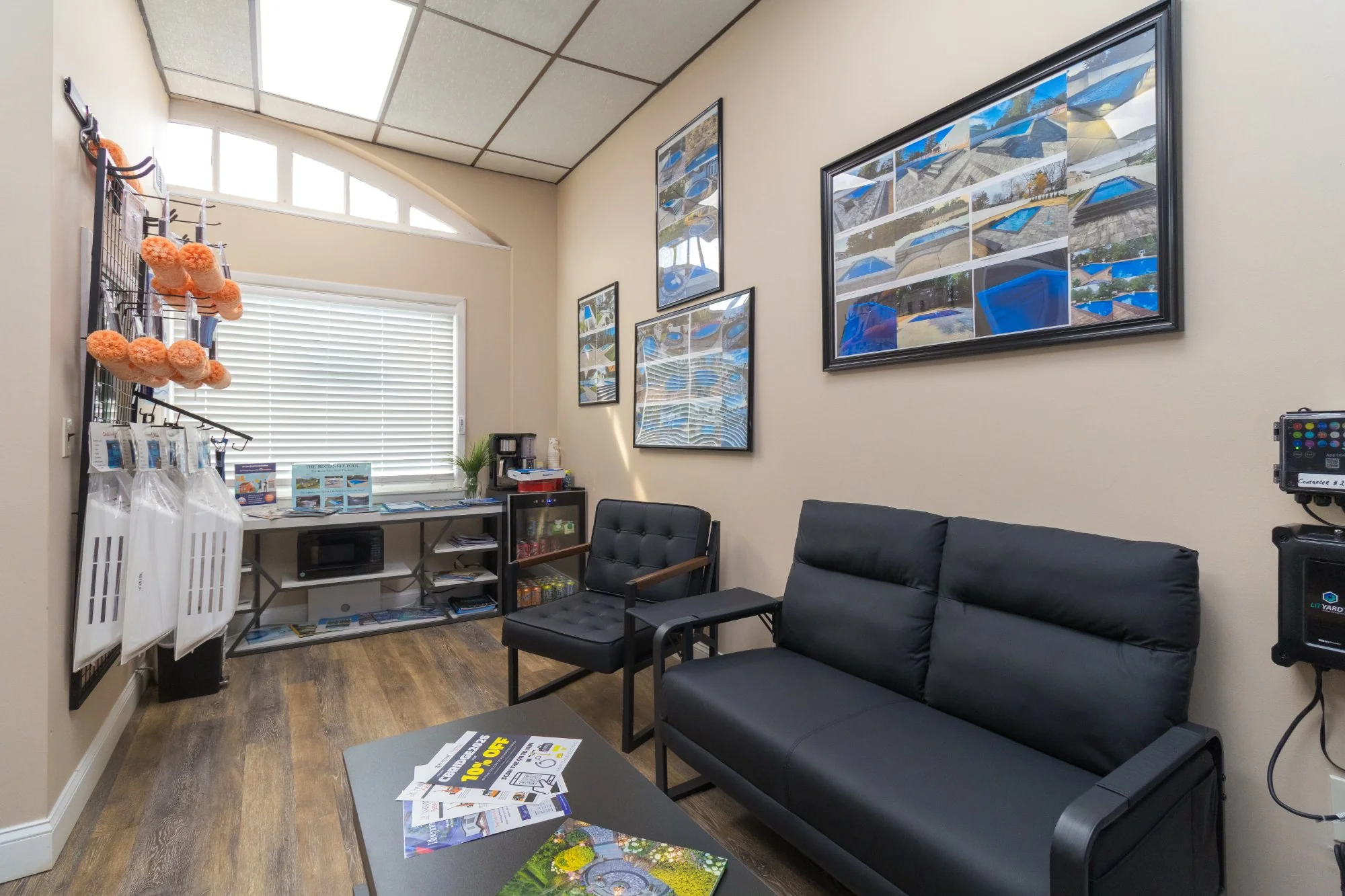 Dr. Zee Pools showroom — seating area with project gallery walls