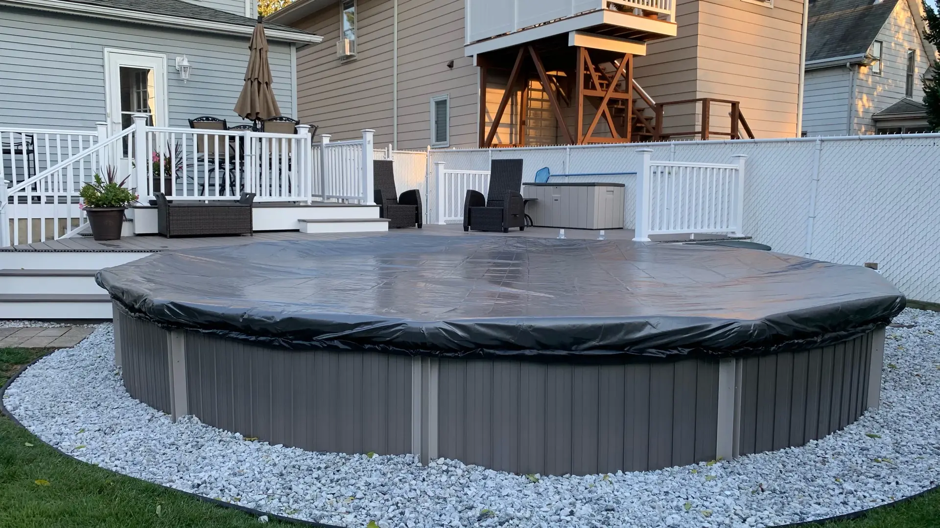Inground pool closed with cover, deck setting