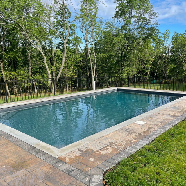 Inground pool open in summer, landscaped yard